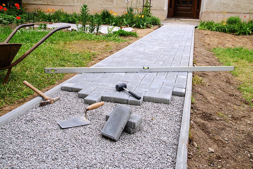 Freshly laid paved area under construction with tools visible