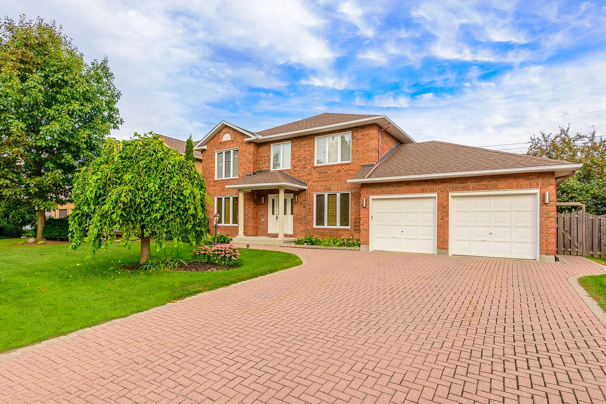 Finished block-paved driveway outside a brick family home